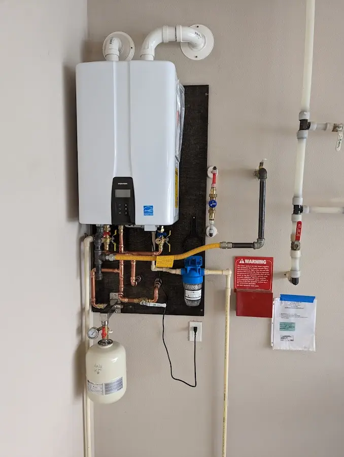 Professional plumber installing copper piping in a Radford home